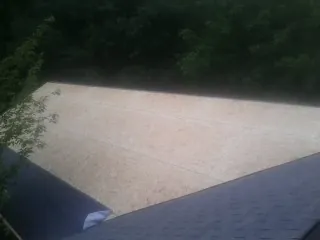 New OSB roof sheathing installed beside an existing shingle roof in Irvine